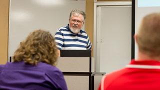 students listen to professor lecture